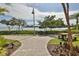A scenic picnic area near the water, featuring a wooden table and grill for outdoor enjoyment at 2739 Via Capri # 1024, Clearwater, FL 33764