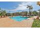 Inviting pool area with lounge chairs and palm trees, perfect for leisure and community engagement at 2739 Via Capri # 1024, Clearwater, FL 33764