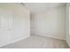 An empty bedroom with neutral carpet, white walls, and white doors at 28776 Rambutan Dr, Wesley Chapel, FL 33543