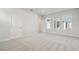 Bright, airy bedroom with multiple windows and neutral carpet, creating a serene atmosphere at 28776 Rambutan Dr, Wesley Chapel, FL 33543