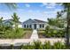 Charming single-story home with a blue accent and beautifully landscaped front yard at 28776 Rambutan Dr, Wesley Chapel, FL 33543