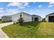 Well-maintained front yard featuring lush green grass and a charming, single-story home design at 28776 Rambutan Dr, Wesley Chapel, FL 33543