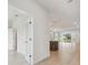 Open-concept view of the modern kitchen and living space with light hardwood flooring at 28776 Rambutan Dr, Wesley Chapel, FL 33543