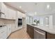 Bright kitchen with white cabinets, stainless steel appliances, island and eat in kitchen area at 28776 Rambutan Dr, Wesley Chapel, FL 33543