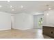 Living room with access to kitchen and a front patio with natural light and light wood floors at 28776 Rambutan Dr, Wesley Chapel, FL 33543