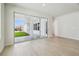 Bright living room with sliding glass doors leading to a covered lanai and backyard at 28776 Rambutan Dr, Wesley Chapel, FL 33543