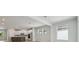 Open-concept living room and modern kitchen with abundant natural light and backyard views at 28776 Rambutan Dr, Wesley Chapel, FL 33543