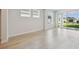 Living room features light wood flooring, neutral paint and a large sliding door to an outdoor space at 28776 Rambutan Dr, Wesley Chapel, FL 33543