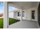 Covered patio overlooking well-manicured lawn and landscaping at 28776 Rambutan Dr, Wesley Chapel, FL 33543