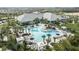 An aerial view showcases the community pool and clubhouse, surrounded by lush landscaping and inviting lounging areas at 29516 Zupetta Ln, Wesley Chapel, FL 33545