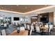 Bright dining area featuring modern lighting, wood tables and seating for residents at 29516 Zupetta Ln, Wesley Chapel, FL 33545
