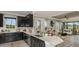 Open-concept kitchen with a large island flowing into the living room and views of the backyard at 29516 Zupetta Ln, Wesley Chapel, FL 33545