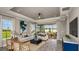 Bright living room with elegant furnishings, tray ceiling, and sliding doors leading to an outdoor patio at 29516 Zupetta Ln, Wesley Chapel, FL 33545