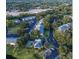 Aerial view of a community with lush greenery, featuring apartments and a sparkling pool at 3001 58Th S Ave # 509, St Petersburg, FL 33712