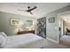 Bright bedroom featuring neutral walls, a modern ceiling fan, and a decorative sliding door at 3001 58Th S Ave # 509, St Petersburg, FL 33712