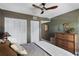Bedroom featuring a wooden dresser, decorative mirror, and stylish ceiling fan at 3001 58Th S Ave # 509, St Petersburg, FL 33712
