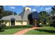Charming clubhouse with blue awnings and a well-manicured lawn in a serene community at 3001 58Th S Ave # 509, St Petersburg, FL 33712