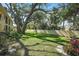 A large community green space with a privacy wall lined with mature trees and lush, tropical foliage at 3001 58Th S Ave # 509, St Petersburg, FL 33712