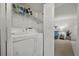 Laundry area with white washer and dryer, shelf storage, and a louvered door at 3001 58Th S Ave # 509, St Petersburg, FL 33712