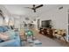 Cozy living room with modern ceiling fan, bar seating and view to kitchen and front door at 3001 58Th S Ave # 509, St Petersburg, FL 33712