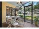 Inviting screened patio with a ceiling fan, tile flooring, and outdoor dining set overlooking a well-manicured yard at 3001 58Th S Ave # 509, St Petersburg, FL 33712