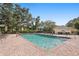 Sparkling community pool with ample lounge chairs and mature trees in a well-maintained outdoor setting at 3001 58Th S Ave # 509, St Petersburg, FL 33712