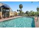 Community pool features clear water, poolside seating, lush landscaping, and a charming clubhouse at 3001 58Th S Ave # 509, St Petersburg, FL 33712