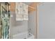 Shower and tub combination with tiled walls, tropical towels, and a mounted shower head at 3001 58Th S Ave # 509, St Petersburg, FL 33712