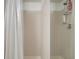 Clean shower with tiled walls, shower curtain, and mounted shelves for toiletries at 3001 58Th S Ave # 509, St Petersburg, FL 33712