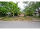 Cozy home with mature trees and lush greenery offers a tranquil setting, appealing to nature lovers at 3027 W Helen Ave, Tampa, FL 33611