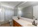 Well-lit bathroom featuring a double sink vanity with wood cabinets and neutral-toned walls at 3329 Cypress Landing Dr, Valrico, FL 33596