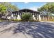 Community clubhouse featuring a covered entrance, stone accents, and professional landscaping at 3329 Cypress Landing Dr, Valrico, FL 33596