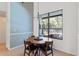 Cozy dining area with a round table and chairs, adjacent to a large window at 3329 Cypress Landing Dr, Valrico, FL 33596