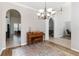 Inviting dining area with a wooden piano and archway to the living room at 3329 Cypress Landing Dr, Valrico, FL 33596