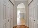 Hallway with archway, leading into a bathroom, with storage closets on both sides at 3329 Cypress Landing Dr, Valrico, FL 33596