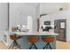 Kitchen island with bar seating, modern stainless appliances and white cabinets at 3329 Cypress Landing Dr, Valrico, FL 33596