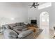 Open living room with gray sectional sofa, archway, and light, bright interiors at 3329 Cypress Landing Dr, Valrico, FL 33596