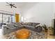 Bright living room featuring a comfortable gray sectional sofa and natural light at 3329 Cypress Landing Dr, Valrico, FL 33596