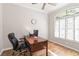 Office featuring wood floors, a large arched window, and a comfortable desk at 3329 Cypress Landing Dr, Valrico, FL 33596