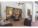 Inviting covered patio with comfortable seating, ceiling fan, and a view of the pool at 3329 Cypress Landing Dr, Valrico, FL 33596