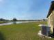 Expansive backyard featuring green grass and a beautiful water view at 35003 Daisy Meadow Loop, Zephyrhills, FL 33541
