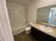 Bathroom featuring a shower-tub combo, vanity, and sink at 35003 Daisy Meadow Loop, Zephyrhills, FL 33541