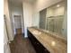 Bathroom features long granite vanity with double sinks and a walk-in shower at 35003 Daisy Meadow Loop, Zephyrhills, FL 33541