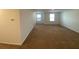 Spacious bonus room features neutral walls and large windows at 35003 Daisy Meadow Loop, Zephyrhills, FL 33541