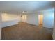 An open bonus room offers neutral walls and carpeted floors at 35003 Daisy Meadow Loop, Zephyrhills, FL 33541