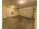 Spacious garage featuring an automatic garage door at 35003 Daisy Meadow Loop, Zephyrhills, FL 33541