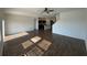A view of the open living room, dining room, and kitchen with hardwood floors at 35003 Daisy Meadow Loop, Zephyrhills, FL 33541