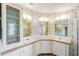 Bright bathroom featuring dual sinks, updated vanity, and shower at 37422 Neukom Ave, Zephyrhills, FL 33541