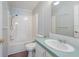 Bathroom features a shower and tub combo and a sink with a large mirror at 37422 Neukom Ave, Zephyrhills, FL 33541