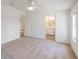 Bright bedroom with neutral walls, carpet, and a bathroom in view at 37422 Neukom Ave, Zephyrhills, FL 33541